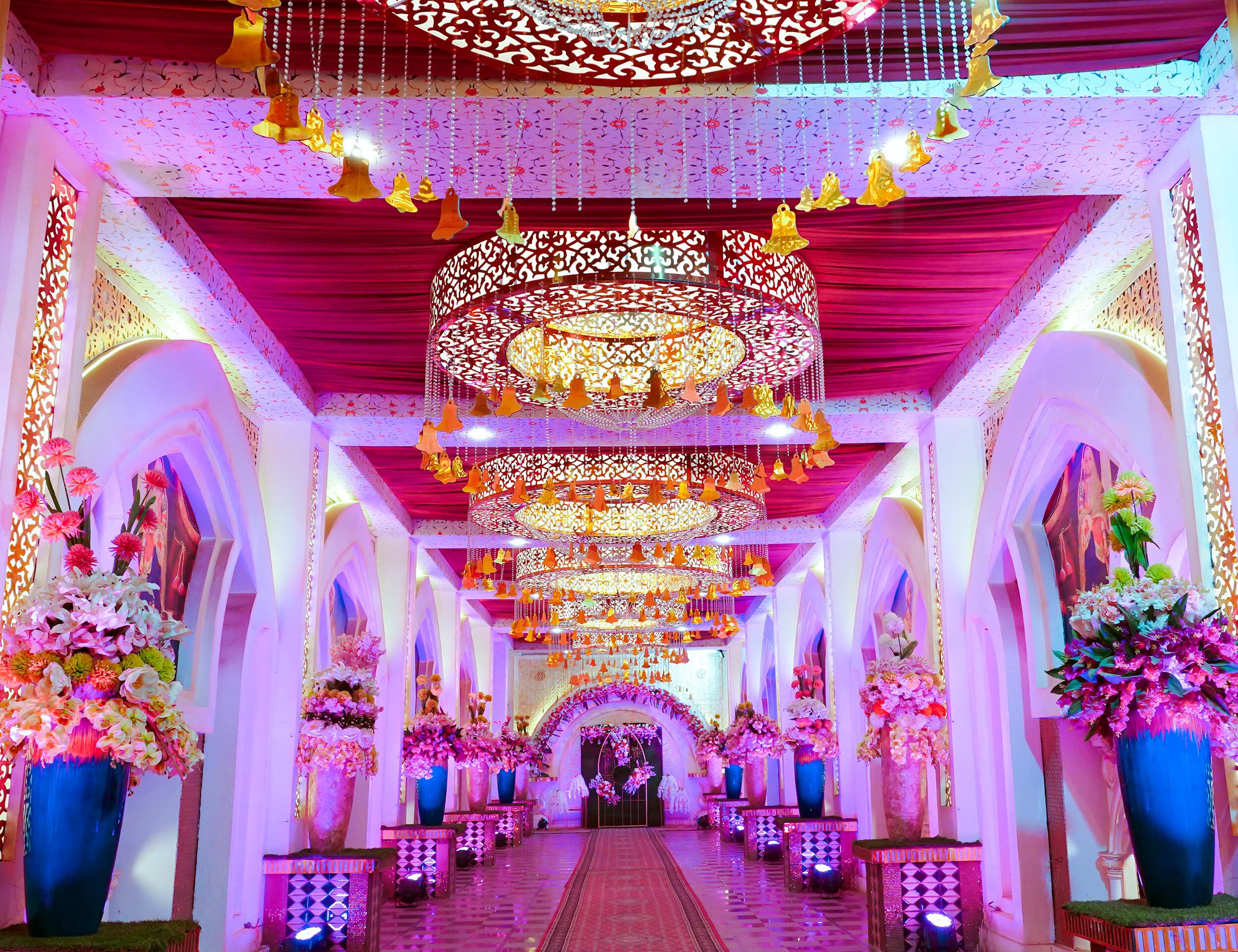 Enchanting bridal entry setup adorned with flower pots on both sides for a dreamy wedding entrance.
